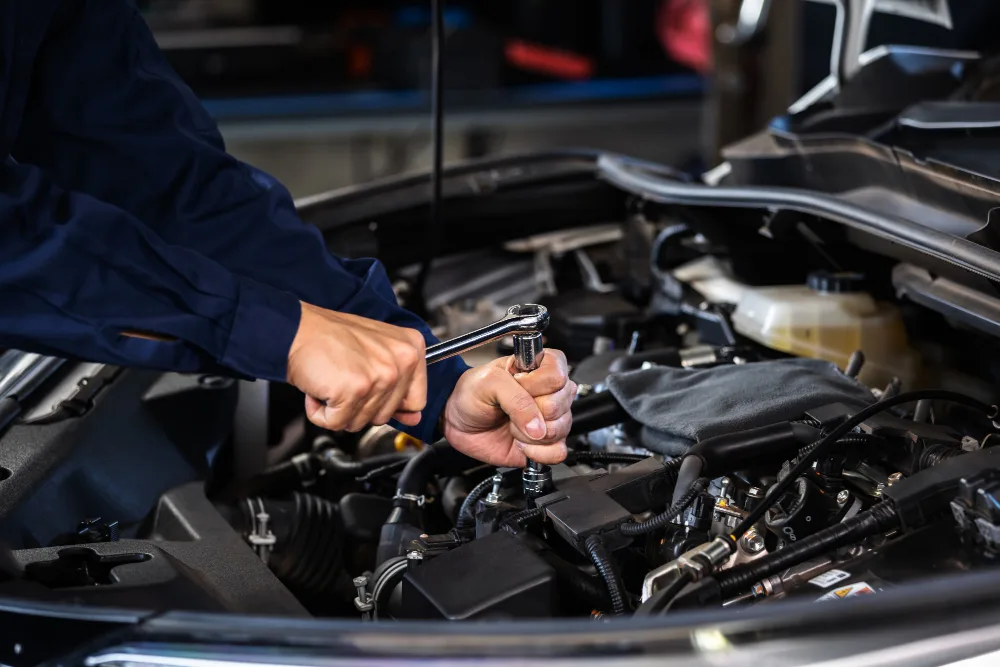 Mechanic performing engine repair and tune-up in Perth
