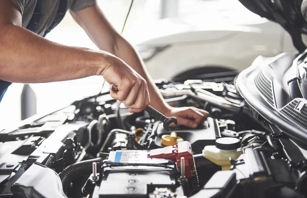 Mechanic performing general car service on engine in Perth